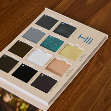 Color swatch book on a wooden surface