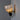 Wall-mounted light fixture with glass shade and gold finish on a gray wall.
