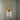 Lamp with gold finish and white glass shade on a gray background