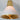 Gold and white pendant light on a gray background