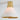 Ceiling light fixture with brass top and white shade on a plain background