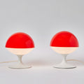 Two red and white table lamps on a light gray background