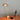 Gold lamp and abstract sculpture on a wooden surface with a gray background