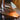 Small desk lamp with white shade on a wooden surface