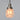 Pendant light with a glass shade on a gray background