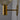 Close-up of a gold wall-mounted light fixture against a gray background