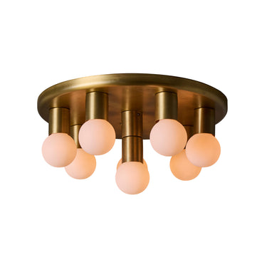 Brass ceiling light fixture with five round glass shades on a white background