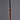 Close-up of a Stilnovo copper pendant with black cord on a gray background for Two Enlighten