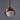 Copper pendant light with a white bulb on a gray background for Two Enlighten