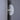 White wall-mounted light fixture on a gray wall