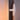 Round light fixture on a wall with a gradient background