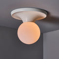 Ceiling light fixture with a spherical bulb on a gray ceiling