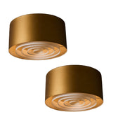 Two gold cylindrical midcentury lights on a white background