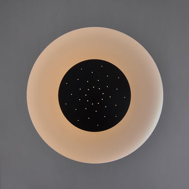 Round light fixture with a black center on a gray background