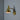 Gold wall-mounted lamp with flexible arm on a gray background
