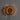 Decorative wall light with circular design casting shadows on a gray wall