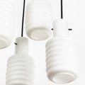 Close-up of white pendant lights with a plain background