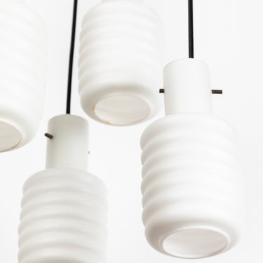 Close-up of white pendant lights with a plain background