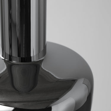 Close-up of a metallic chrome VL56 pendant with a reflective surface on a gray background