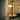 Small round table with two gray cups under a pendant light in a room with architectural details.