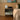 Modern bedroom with a nightstand, lamp, and abstract painting on the wall.
