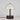 Table lamp with a white shade and black base on a light gray background
