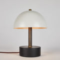 Table lamp with a white shade and black base on a light gray background