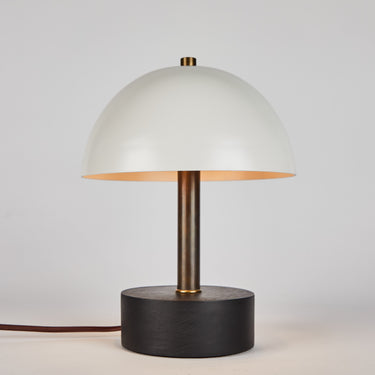 Table lamp with a white shade and black base on a light gray background