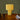 Yellow geometric table lamp on a wooden surface with books and candles
