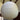 A large spherical white paper lantern pendant light hanging from a ceiling with dark wood beams.