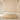 Beige deep shag rug on a light wooden floor with a white jean prouvé chair against a beige wall.