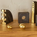 aubock egg brass paperweights on an oak chapo bookshelf