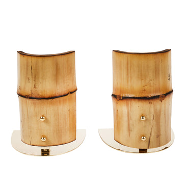 Pair of wooden bookends with gold accents on a white background