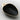 Black ceramic dish with gold rim on a light gray background