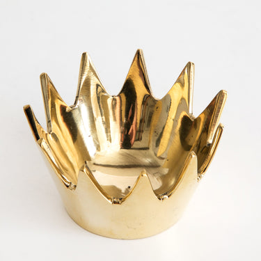 Gold crown-shaped object on a white background