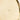 Gold-colored circular object with a brand name on a light background
