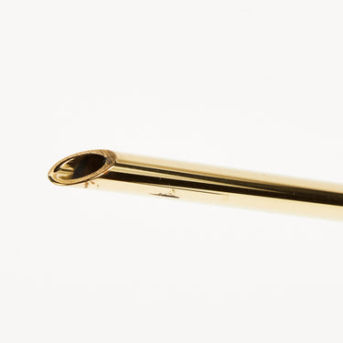 Gold-colored metal rod on a white background
