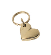 Gold heart-shaped pendant on a light gray background