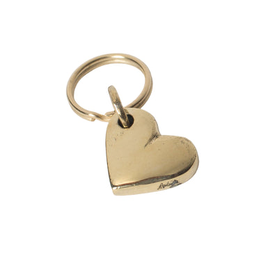 Gold heart-shaped pendant on a light gray background