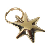 Gold star-shaped keyring on a light gray background