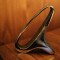 brass bookend on a wooden stand against a wooden background