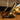 brass bookend on a wooden surface with blurred background