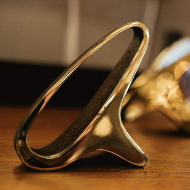 brass bookend on a wooden surface with blurred background