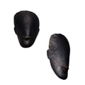 Two black brass toscanini head sculptures on a white background