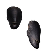 Two black brass toscanini head sculptures on a white background