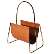 Brown leather magazine holder with gold metal frame on a white background by carl aubock