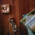 aubock paperweight chain link on a wood table