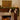 Decorated fireplace with stockings, candles, and a wooden wall art piece.