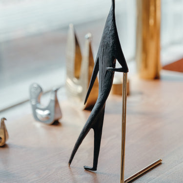 aubock man with stick on ledge