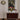 Wooden cabinet with marble top in a room with a poster on the wall.